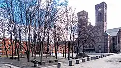 A view of Providence's Cathedral Square on a sunny winter day. At left is a grove of trees without leaves.