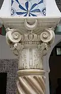 Composite capital of white marble, decorated with a crescent.