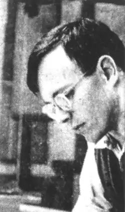A black and white photo of Fisk working on an organ.