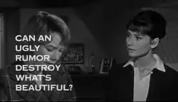 Still shot from the film "The Children's Hour", showing Shirley MacLaine looking down at the left and Audrey Hepburn to her right staring at her, in a bedroom. The words "Can an ugly rumor destroy what's beautiful?" obscure much of MacLaine's face.