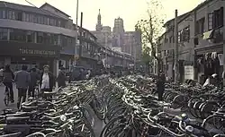 A very large number of bicycles parked along a street in Shanghai