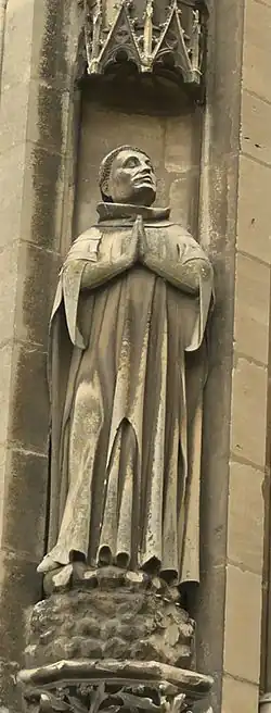 Statuette on a dais.