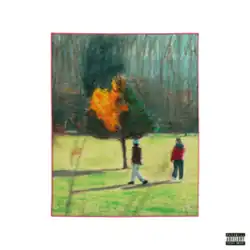 A photograph of two people walking around a burning green tree in the middle of a field, surrounded by a white border