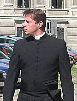 A Roman Catholic seminarian wearing a cassock with a clerical collar