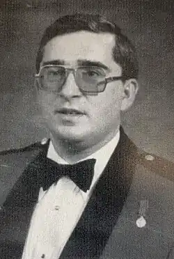 Colonel J R W McLauchlan, SDG Highlanders. Black and white photo of a white man with square rimmed glasses, wearing a tuxedo. Has a faintly visible medal on his left shoulder.