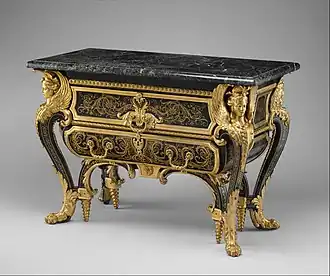 Commode; by André Charles Boulle; c. 1710–1732; walnut veneered with ebony and marquetry of engraved brass and tortoiseshell, gilt-bronze mounts, antique marble top; 87.6 x 128.3 x 62.9 cm; Metropolitan Museum of Art[172]
