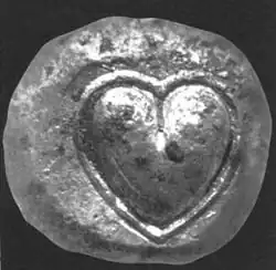 Ancient silver coin from Cyrene, Libya depicting the heart-shaped "seed" (actually fruit) of silphium