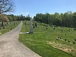 big cemetery in field with walkway in middle
