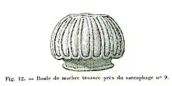 Black and white sketch of a sculptural element. The object is oval in shape and features longitudinal carvings.