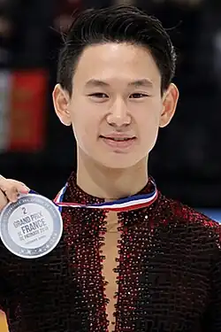 Denis Ten receives the silver medal at the 2016 Trophée de France.