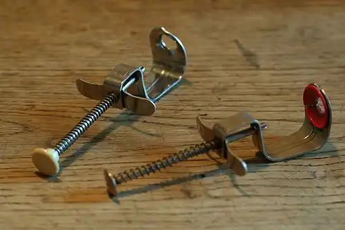 Cherry pitters with spring mechanism