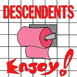 An album cover shows an illustration of a white tile bathroom wall, with a roll of pink toilet paper hanging from a holder. Across the top of the cover is the band's name, "Descendents", in large, red capital letters. Across the bottom is the album title "Enjoy!" in large, red, cartoon-style lettering.