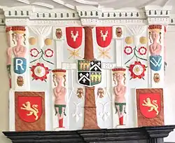Fireplace in the hall, showing the quartered arms of the Wynn family, surrounded by badges and caryatids