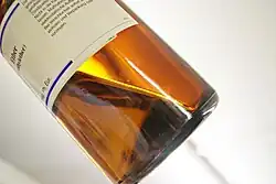 Diethyl ether liquid in a brown-tinted glass bottle