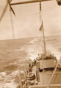 Water is churned up behind the cutter as she moves forward