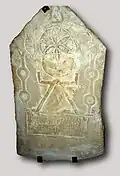 Stele with sign of Tanit, intersecting moon and rosette, and pomegranate.