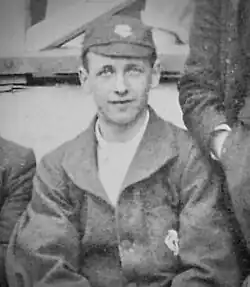 Monochrome photograph of Priestley dressed in Tewkesbury Cricket Club colours and cap.