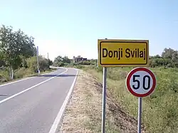 Donji Svilaj village sign. On both sides of the road at the Donji Svilaj eastern boundary are ruins of Miletić family houses, all destroyed in Yugoslav war.