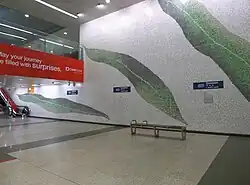 A mural made up of tiles depicting several leaves