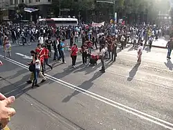 Protesters drawing chalk outlines of human bodies and doves with fake blood on Eje Central
