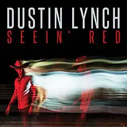 A man covered in a red light. Behind him is a stream of light and duplicate image of himself. The artist's name and song title appear above, colored in white and red respectively.