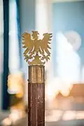 Detail of Tredje kurators staff that is crowned by a two-dimensional eagle. Gift to the nation from Wermländska Sällskapet.