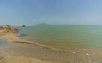 Photograph of the lake with a beach in the foreground