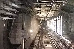 The installation of screen doors has started at the reserved platform structure in the eastbound tunnel of Line 6, and the previously installed site lighting strips are still visible (June 2022)
