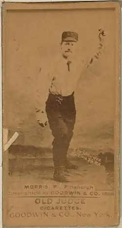 A baseball card featuring a player wearing a white shirt and dark pants throwing a baseball. The bottom of the card reads "MORRIS, P., Pittsburgh Copyrighted by GOODWIN & CO. 1888"