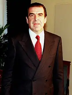 Image 14A man wearing a power suit, popular in the European workplace. The suit jacket is double-breasted with large shoulder pads. Photograph taken in 1998. (from 1990s in fashion)
