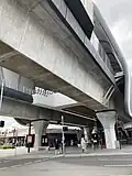The station concourse and the north-west end of the elevated platforms viewed from Murrumbeena Road, September 2024