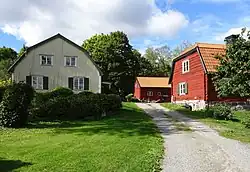 Image of two red barns and a farmhouse
