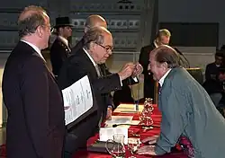 Photograph of Marco being presented with a medal