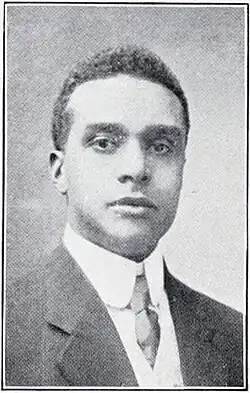 Black and white photograph from the bust up of a man in a suit and tie