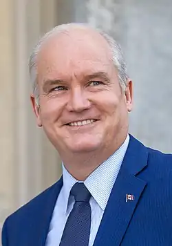 Photograph of O'Toole smiling. He is wearing a navy blue suit with a Canadian lapel pin.