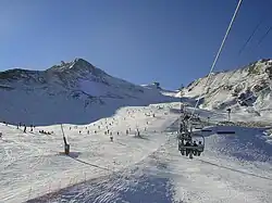 The ski lift and piste at Pas de la Casa with the Pic d'Envalira in the background