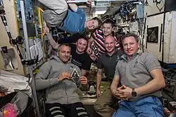The newly expanded six-member Expedition 57 crew poses for a portrait inside the International Space Station's Zvezda service module on December 10, 2018