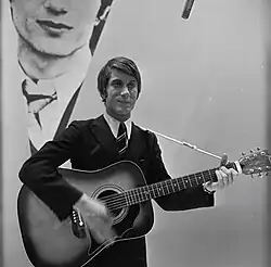 Jacques Dutronc with a guitar on a 1966 television broadcast