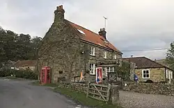 A stone cottage by a country road