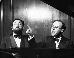 Photo of Flanders and Swann singing at the piano