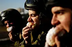 Israeli soldiers enjoying sufganiyot as part of their Hanukkah festivities