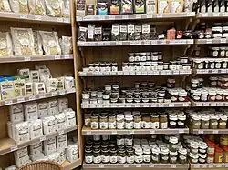 Various flours, pickles, fruit preserves, and herbal teas on display