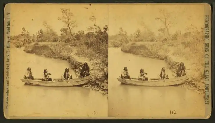 Four Indian men in a boat on Ponca creek