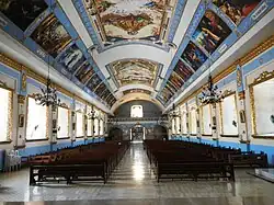 Church nave from the sanctuary showing the ceiling paintings
