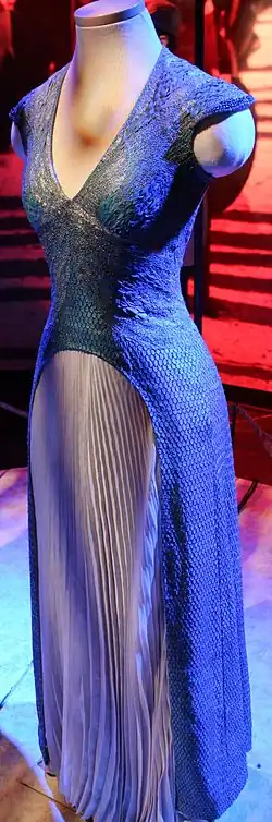 A blue, scale-covered dress on display.