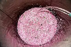 A container being filled using a hose