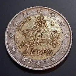 Greek 2 Euro coin 2002 featuring the word Europa and depicting a woman sat astride a bull.