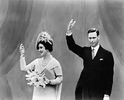 King George VI and Queen Elizabeth of the United Kingdom, who are photographed waving during a visit to the fair