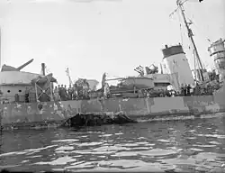 A close-up of the hole in the starboard side of the ERIDGE caused by a torpedo