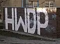 A two-metre-tall inscription of HWDP, on a wall in Zielona Góra